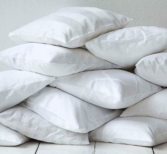 Photo of a pile of clean white puffy pillows