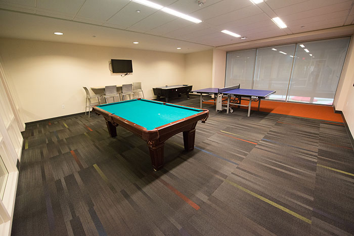 Room with Ping-Pong, air hockey, pool tables, and TVs.