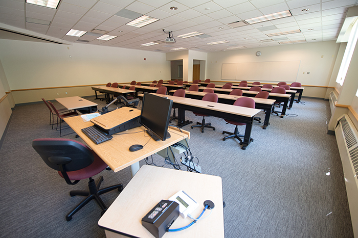 Large classroom-like space with tables/seats for 40+ and instructor table.