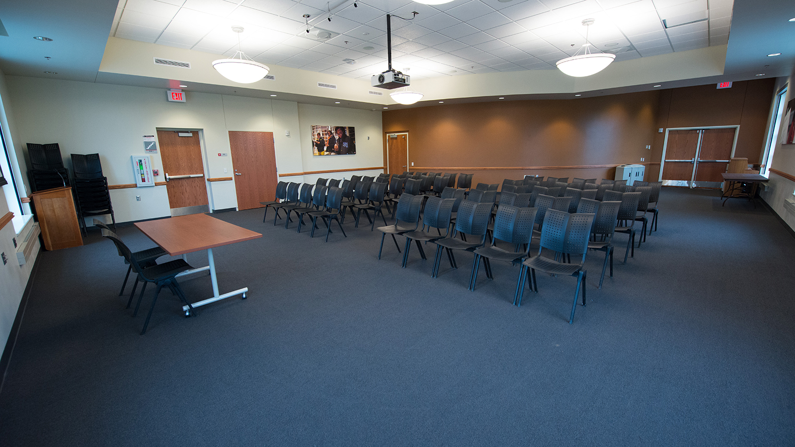 Meeting room in Gaughan Center filled with chairs and projector.