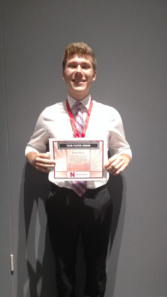 2018 Team Player Award recipient Jonas Price holding his award certificate.