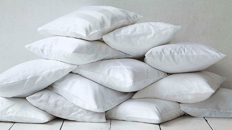 Photo of a pile of clean white puffy pillows