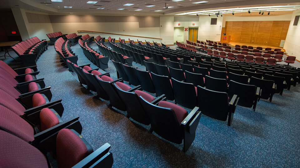 Inside of auditorium with stage and lectern.