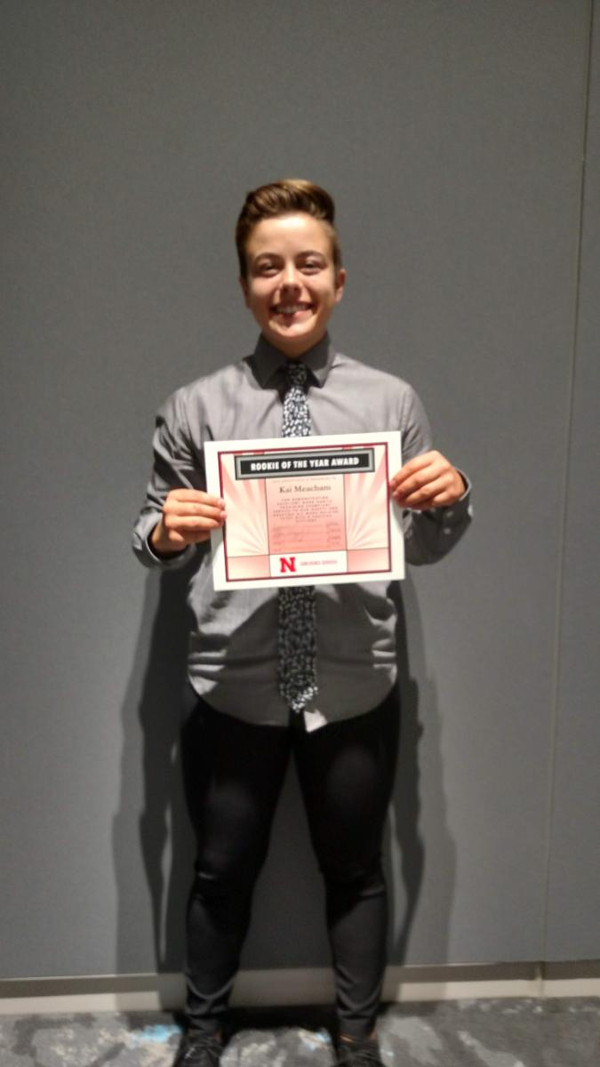 2018 Rookie of the Year Award recipient Kai Meacham holding their award certificate.